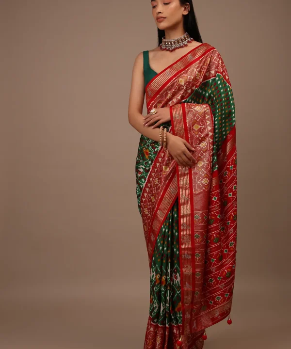Bottle Green Saree In Silk With Multi Colored Patola And Foil Print And Contrasting Red Border